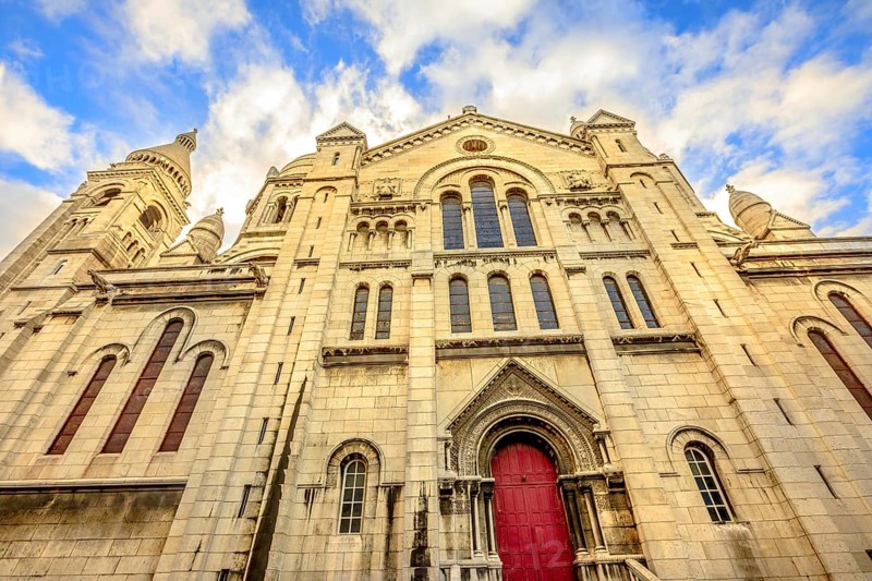 Left side facade and door of Basilique Sacred Heart in Montmartre of Paris in France with no people. Popular religious attraction in Paris city of France, Europe, Paris, Francia