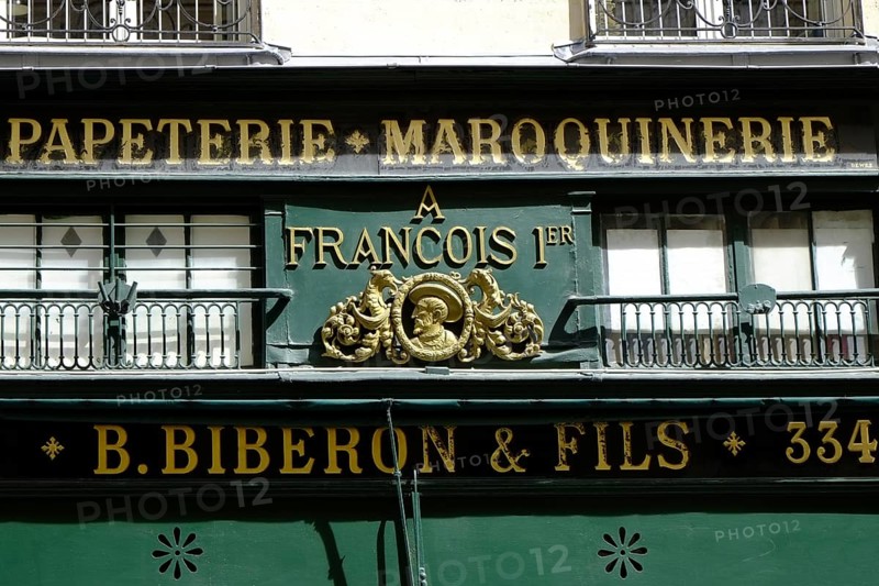 Shop front with golden letters on a green background. Landscape format. Front of a shop with golden letters on a green background. Horizontal format