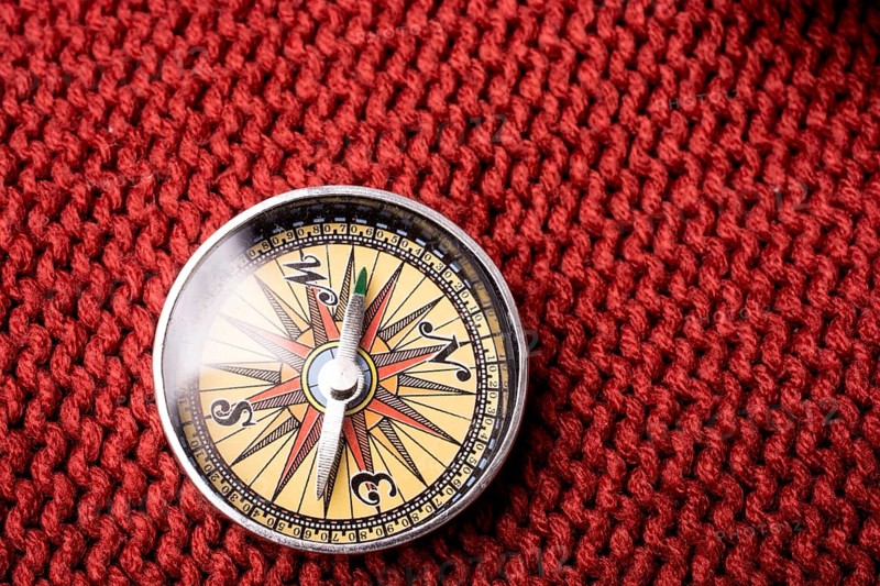 Compass tool on red texture fabric