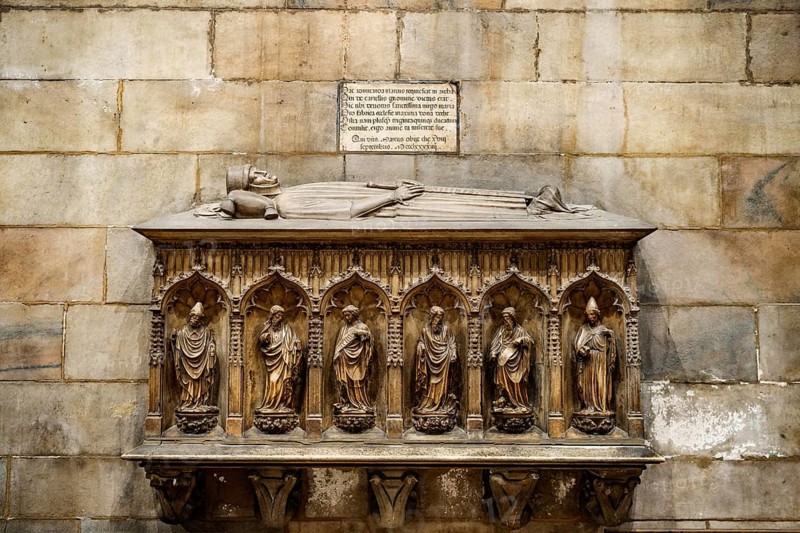 Stone headstone in the Duomo. Milan, Italy.