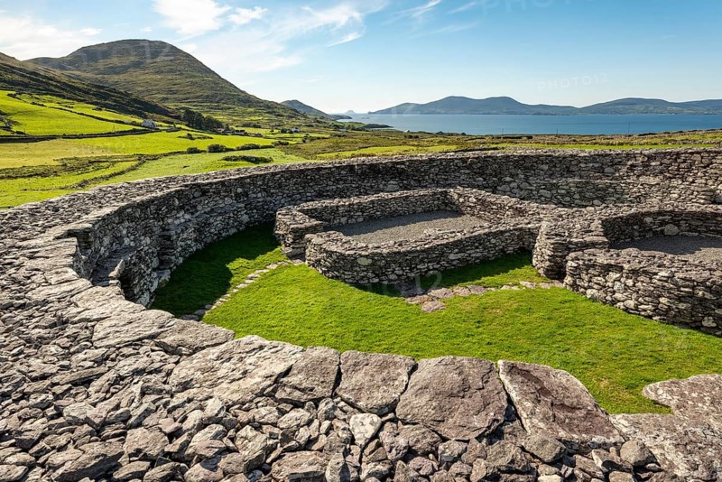 Loher Stone Fort at Caherdaniel overlooking green pastures and the sea under a clear blue sky, Ring of Kerry, Iveragh Peninsula, County Kerry, Ireland, Europe