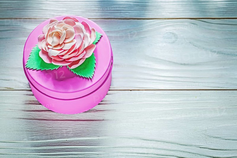 Round pink present box on wooden board celebrations concept