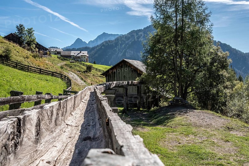 An old wooden inlet channel of a watermill in Val di Morins, the Dolomite Alps of South Tirol