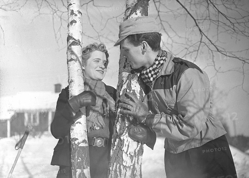 Winter in the 1940s. A young couple is enjoying their winter vacation, and they are wearing the typical winter fashion clothes of the 1940s. Sweden February 1940. Photo Kristoffersson Ref 68-9