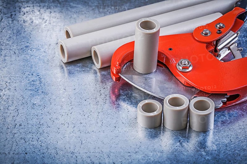 Set of pipe coupling tools on metallic background construction concept