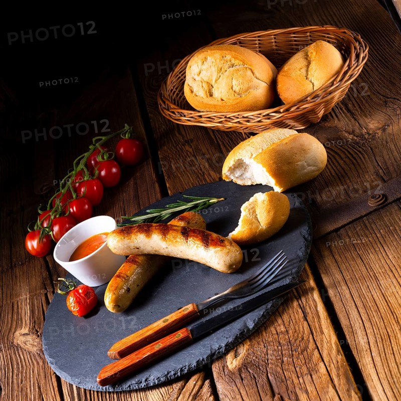 Rustic bratwurst with ketchup and fresh rolls