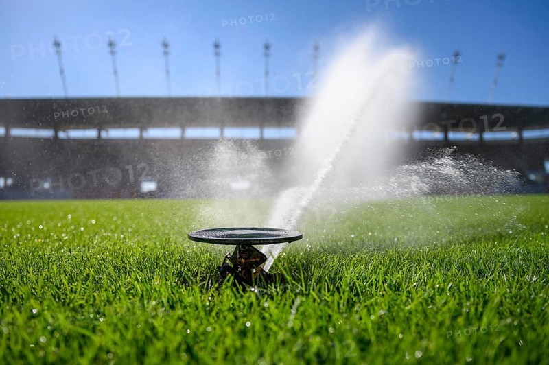 Watering grass on a football stadium in Lubin, Poland, Europe