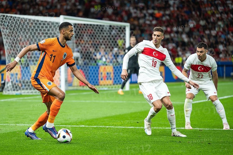 BERLIN, GERMANY - JULY 6, 2024: Euro 2024 quarterfinal match Nederlands vs Turkey (Turkiye) 2:1. In action Cody Gakpo (L) Mert Muldur (M) Kaan Ayhan (R)