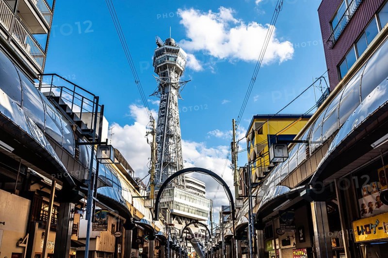 OSAKA, JAPAN - SEPTEMBER 26 2024: The famous Shinsekai area with Tsutenkaku Tower on a clear autumn day in Osaka, Japan, Asia