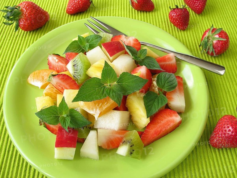 Fruit plate decorated with honeydew melon and sage