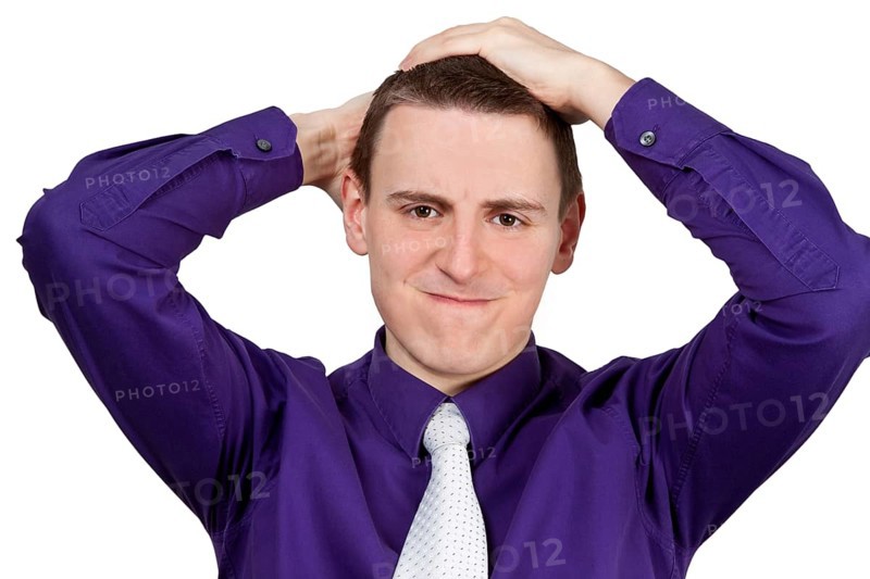 Young man with shirt and tie ruffling his hair - optional