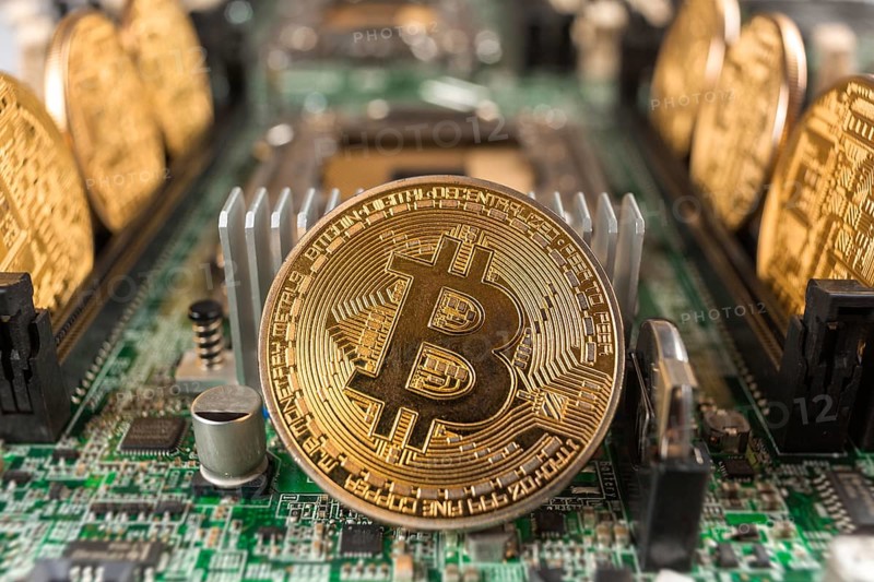 Bitcoin close-up on a computer circuit motherboard as a blockchain technology payment network. Digital cryptocurrency concept and mining