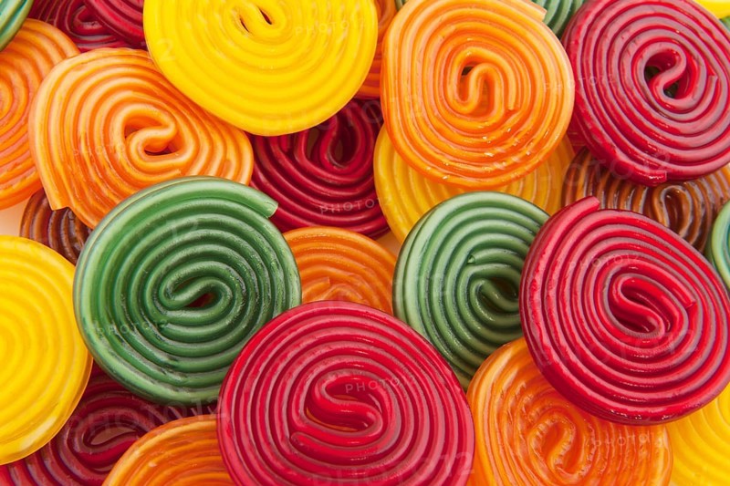 Colorful licorice candy drop rolls as background