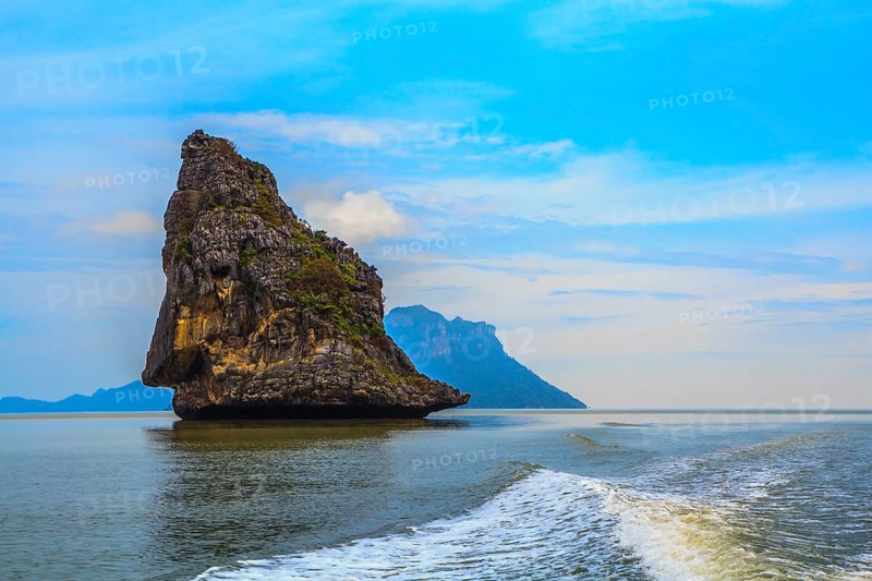 Island Sail in the Andaman Sea. Fantastic beauty island-rock in the southern seas. The photo was taken from a fast sailing boat