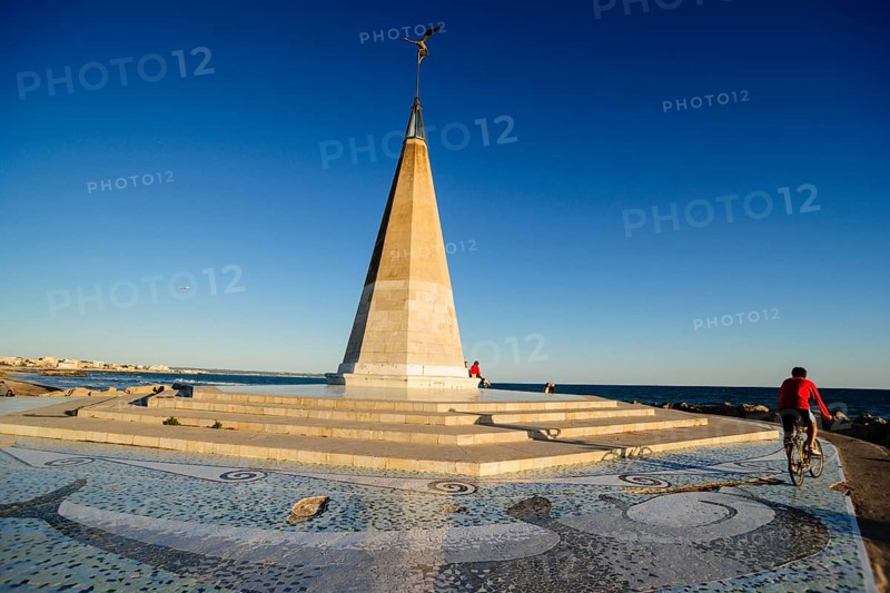 Cyclist next to the monument, Paseo del Molinar, Palma, mallorca, balearic islands, spain