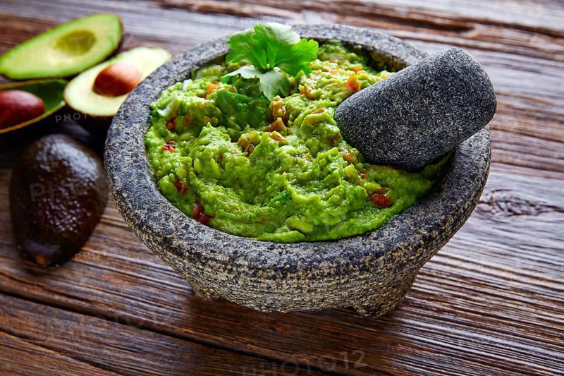 Avocado Guacamole on molcajete real Mexican traditional procedure