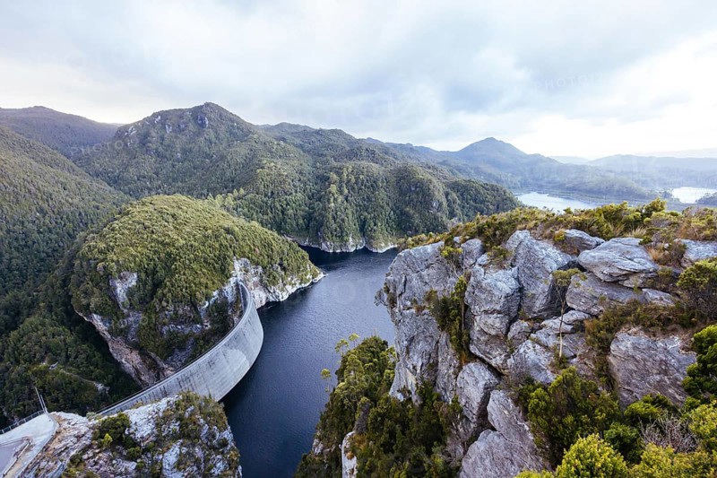 View of the Gordon Dam on a cool summer's day. It is a unique double curvature concrete arch dam with a spillway across the Gordon River near Strathgordon, South West Tasmania, Australia, Oceania