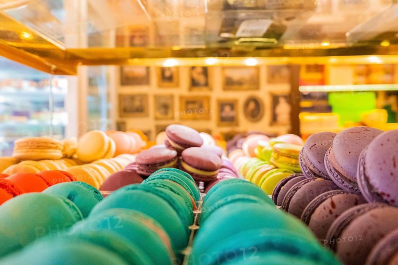 Close-up of macarons cakes of different colors in a patisserie. Culinary and cooking concept. Tasty colourful macaroons