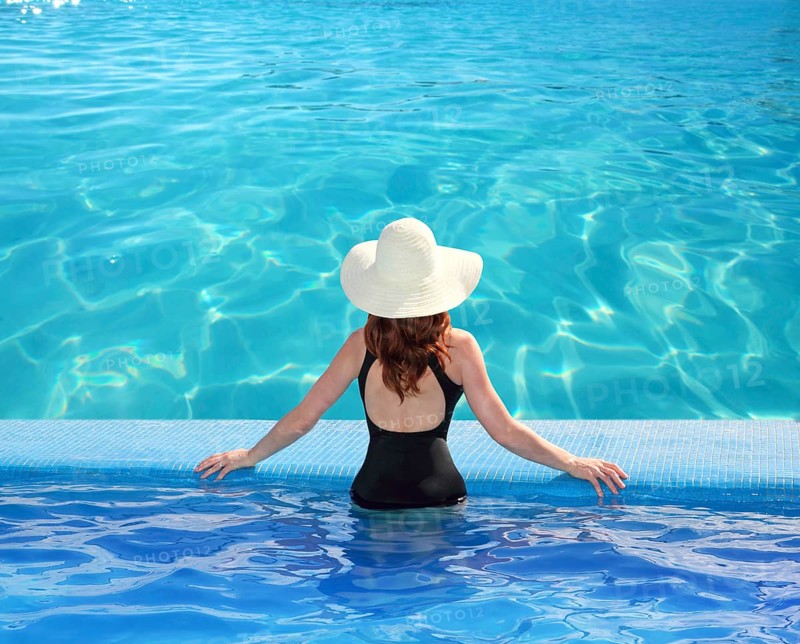 Caribbean tropical sea view from blue pool rear woman beach hat