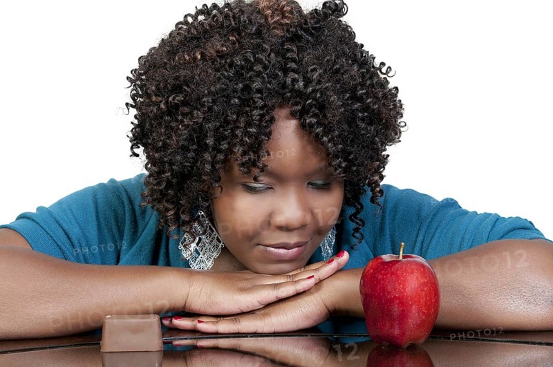 A woman trying to decide whether or not to eat healthy