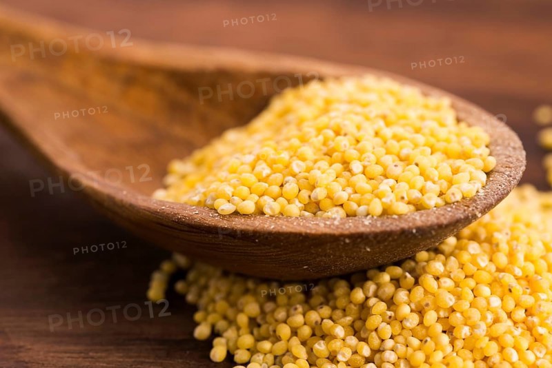 Millet on wooden spoon