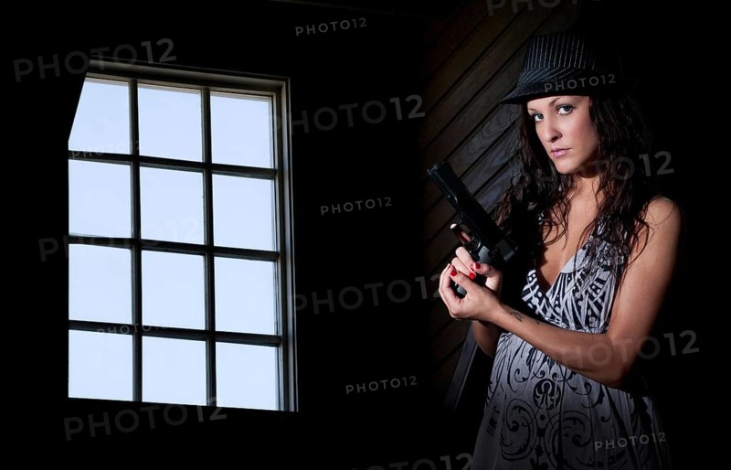 A beautiful police detective woman on the job with a gun