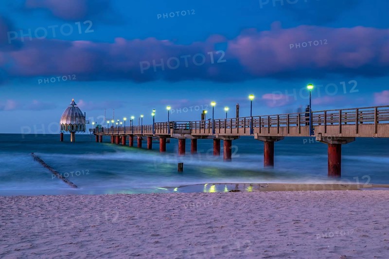 Stormy evening at the Coast of the Eastsea on an autumn day with the sea bridge at Zingst and beautiful sky. Night at the Coast of the Eastsea on an autumn day with the sea bridge at Zingst and beautiful sky