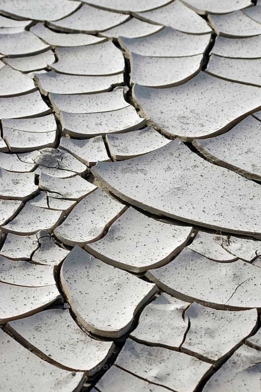 The top view and close-up of a dried out and fragmented layer of soil