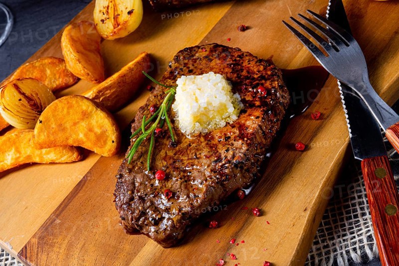 Butter beef steak with herbs and potato wedges