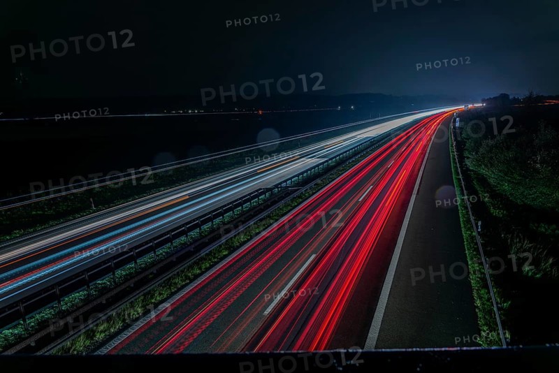 Long exposure of a motorway at night with red and white light trails representing speed and movement, Kirchroth, Lower Bavaria