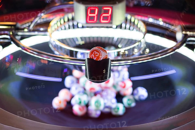 Colourful lottery balls in a rotating bingo machine. Number 23