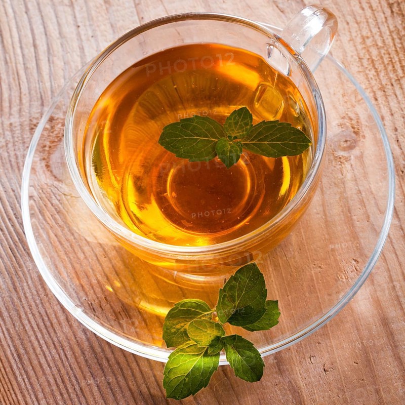 Mint tea in glass cup on wooden table