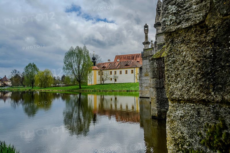 River landscape with stone bridge and historic buildings, reflections on water, cloudy sky, Tirschenreuth, Upper Palatinate, Bavaria, Germany, Europe