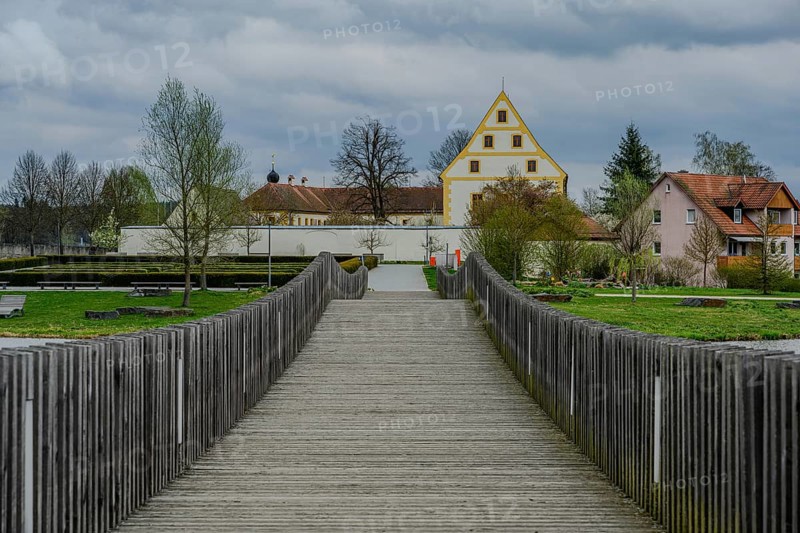 Wooden bridge leads to a historic building in a green park landscape, Tirschenreuth, Upper Palatinate, Bavaria, Germany, Europe