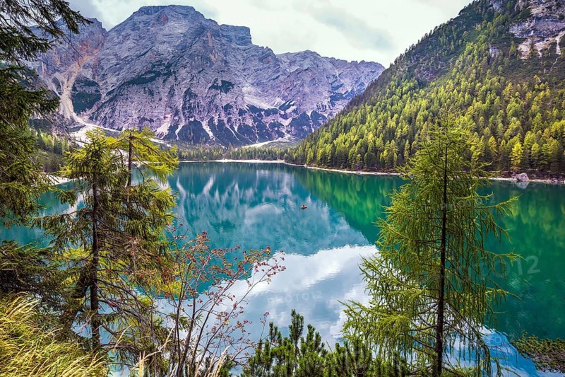Stroll around the beautiful alpine lake Lago di Braies. The concept of walking and eco-tourism. Travel to South Tyrol, Italy, Europe