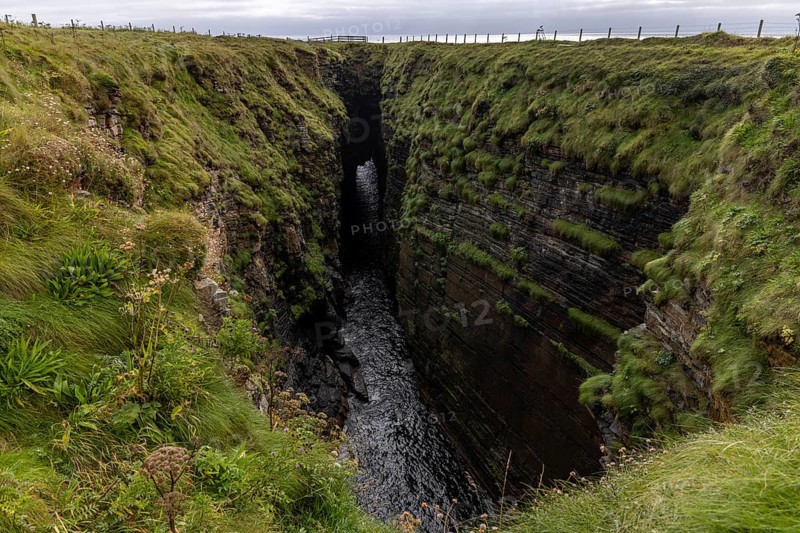 The Gloup, collapsed cave with small waterfall, Mull Head Local Nature Reserve, seaside nature reserve, Skaill, Orkney, Scotland, United Kingdom, Europe