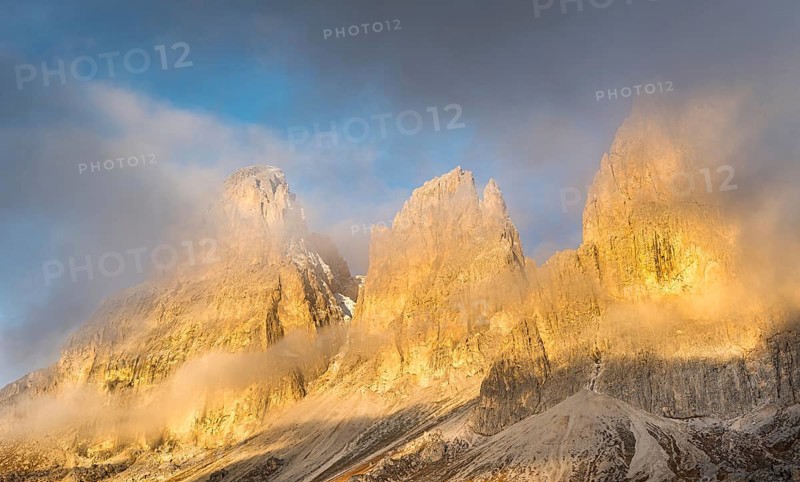 Foggy mountain landscape during sunrise of the picturesque Dolomiti at Passo Sella area in South Tyrol in Italy