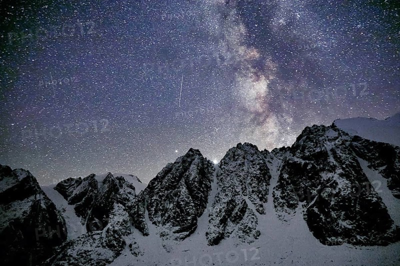 Milky Way and snowy mountains in Altai at night