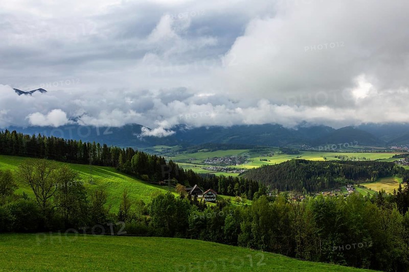 Meadow, farmland and forest area, fog in the background over Reiting massif, view from the lowland, Leoben, Styria, Austria, Europe