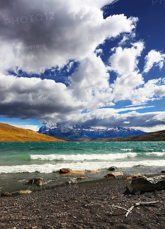 Stormy wind blows the clouds over the lake Laguna Azul. National Park Torres del Paine. Patagonia, Chile, South America