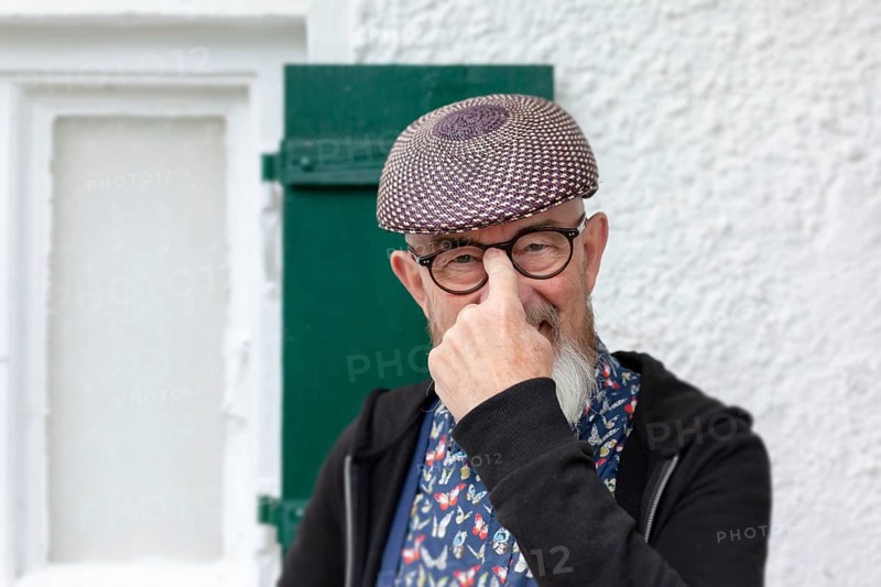 An image of an old man with a beard outdoor