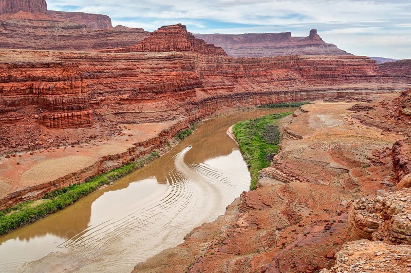 A jetboat transporting kayaks upstream of Colorado River below Moab in Utah