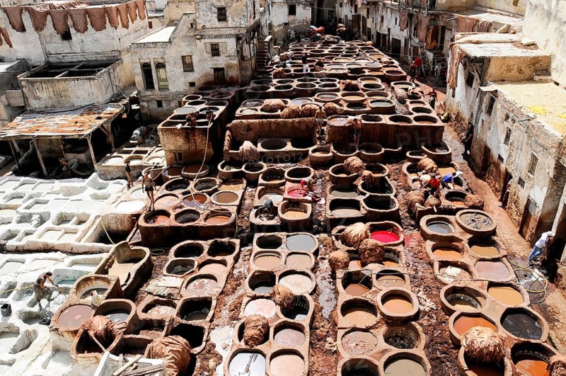 Workers, Chouwara tanners' and dyers' quarter in Fes El Bali, Medina, UNESCO World Heritage Site, Fes, Craftsmen working on leather in a traditional tannery, Northern Morocco, Morocco, Traditional Moroccan tannery with numerous round barrels in a city environment, Fes, Northern Morocco, Morocco, Africa