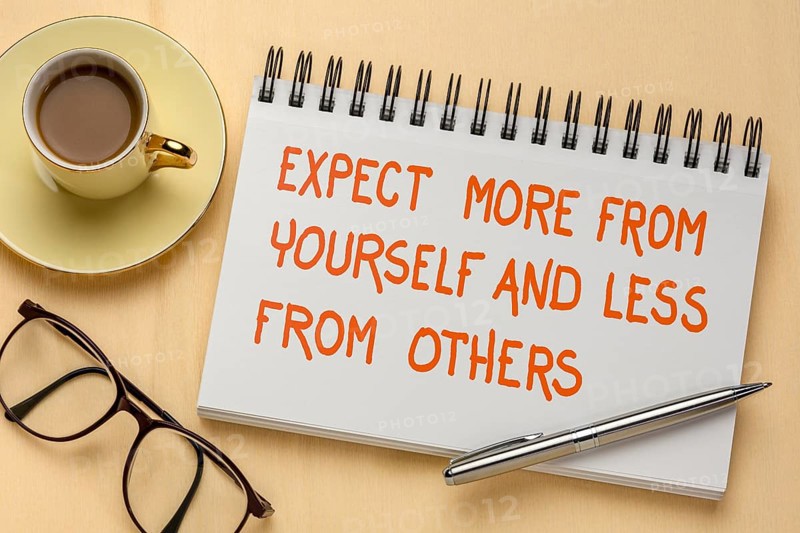 Expect more from yourself and less from others - inspirational handwriting in a sketchbook, a flat with coffee and glasses, people skills, relationships, and personal development concept