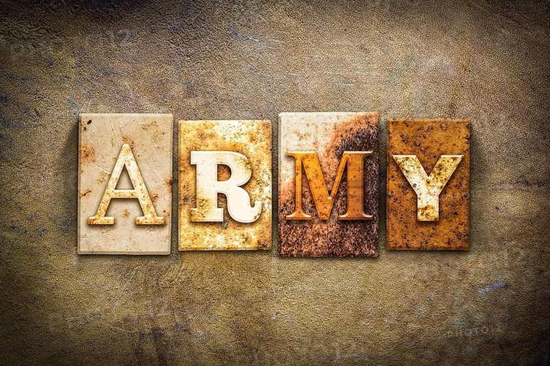 The word ARMY written in rusty metal letterpress type on an old aged leather background