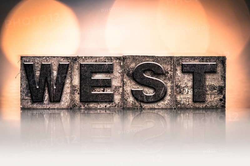The word WEST written in vintage ink stained letterpress type