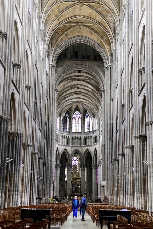 Rouen Cathedral, Rouen, Département Seine-Maritime, Region Haute-Normandie, France, Europe, Majestic gothic interior of a cathedral with high vaults and a visitor, Seine-Maritime, Haute-Normandie, Europe