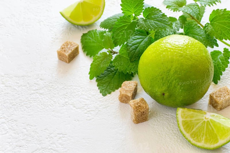 Ingredients for Mojito. Juicy lime, mint and brown sugar, copy space