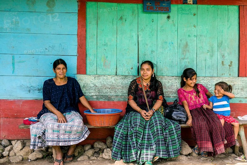 Women in front of a colorful wall, Lancetillo, La Parroquia, Reyna area, Quiche, Guatemala, Central America