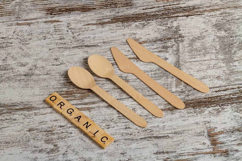 Rural wooden spoons and knives top view. Organic word made of cubes